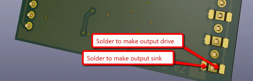 Close-up of two solder jumpers on the board, labelled 'Solder to make output drive' and 'Solder to make output sink'